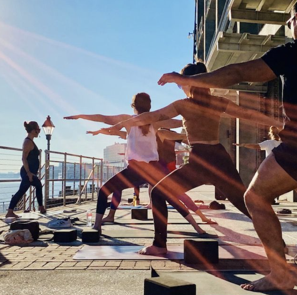 Yoga class on the riverwalk at Plant Riverside District